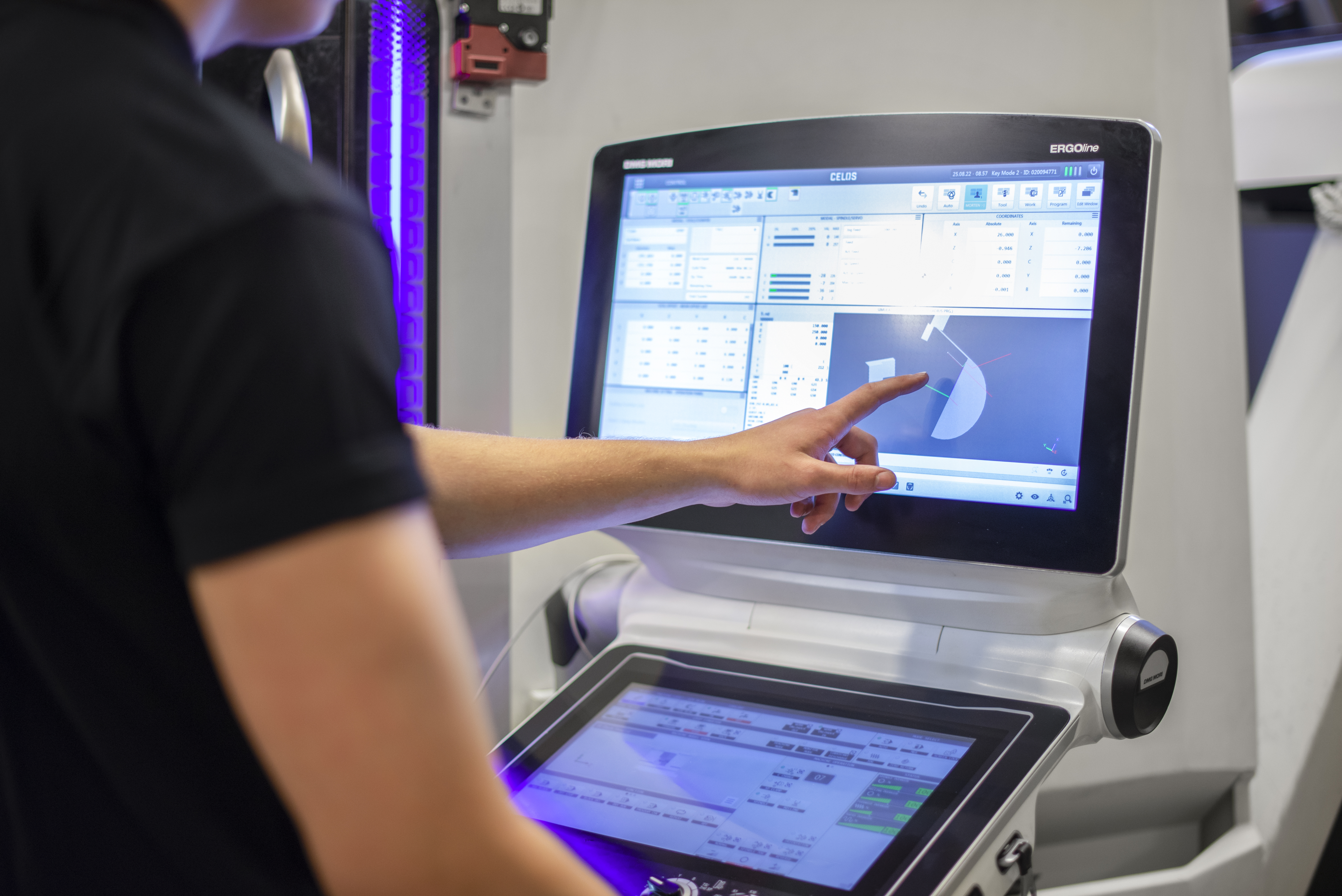 Intermec CNC operator reviewing a program at the machine control