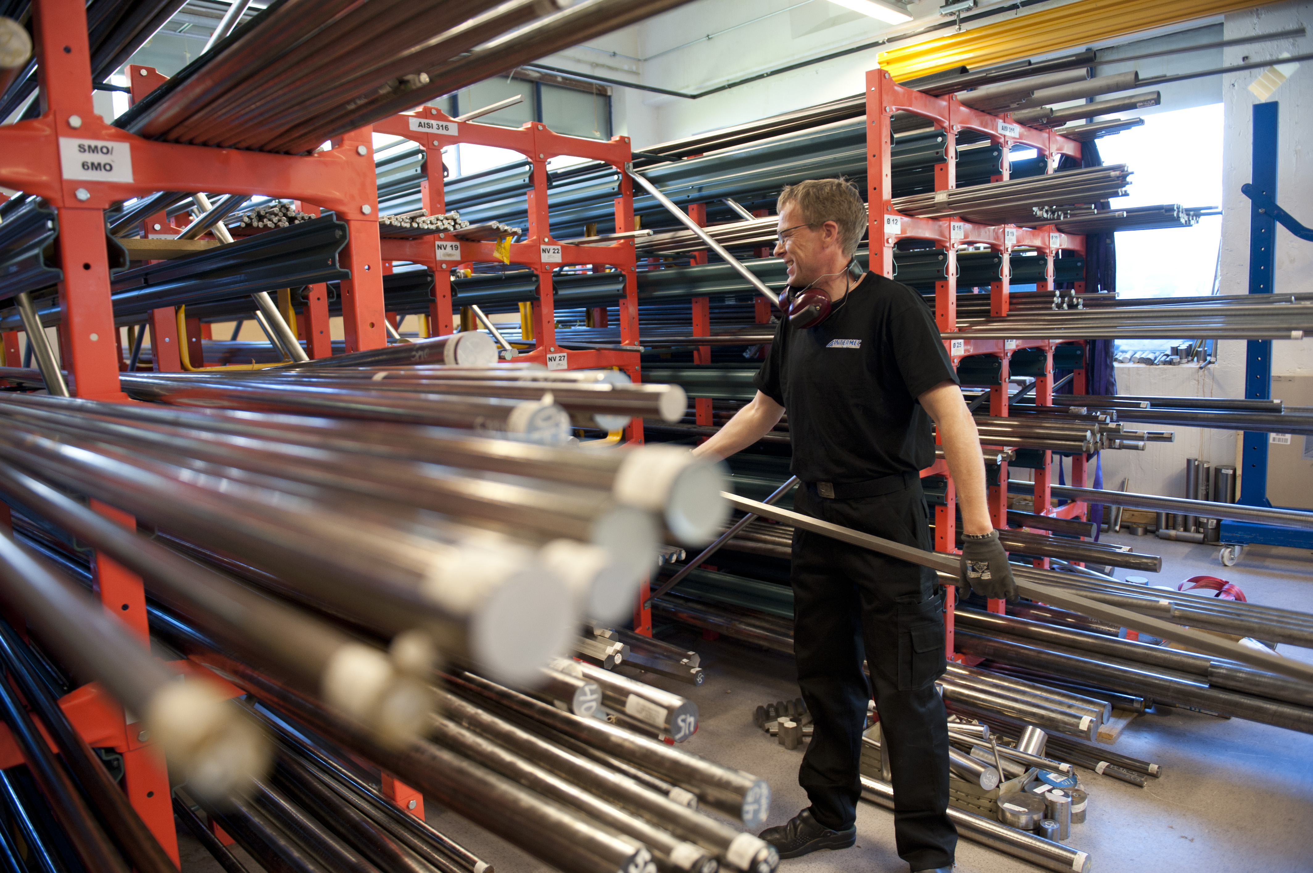 Employee selecting metal bar stock in the Intermec raw material warehouse